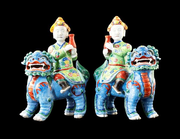 GG: Pair of Chinese porcelain famille rose figures of riders on Buddhist lions
